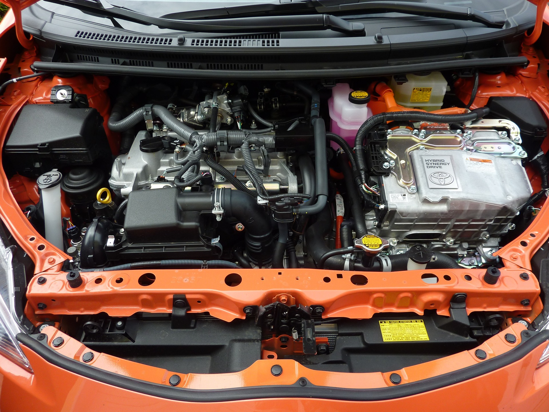 A picture inside the open hood of a Prius. You can see that the engine is really compicated and intricate